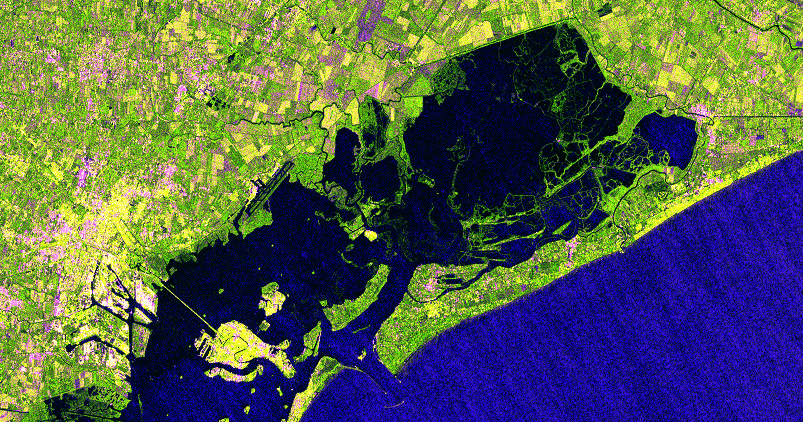 post-flood satellite image with floodwaters overtaking farmland and urban areas near the lagoon