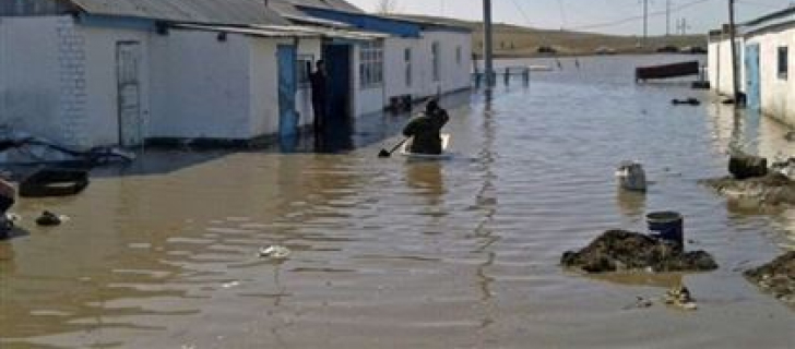 a man swimming through the flooded streets of Kazakhstan