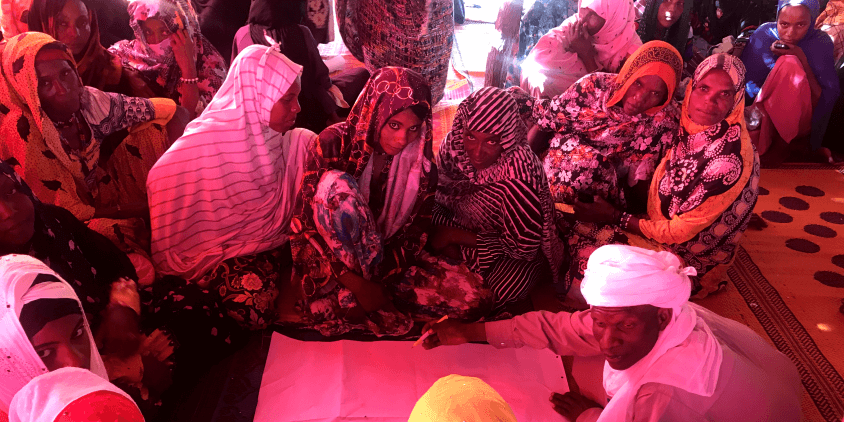 women negotiating around the map